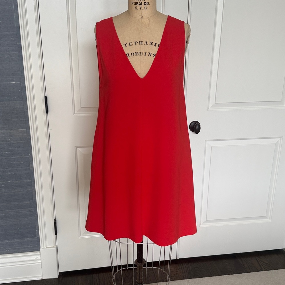 Theory Vibrant Orange Dress with pockets.
Deep V in front and back.